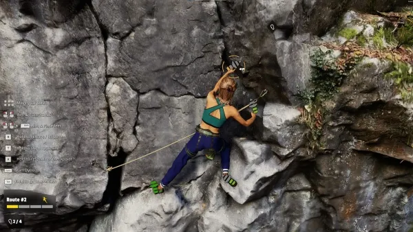 A female rock climber in a green tank top and blue pants scales a rugged cliff face, her safety rope secured. She uses her climbing shoes to grip the jagged rocks as she carefully navigates the challenging terrain. The scene is set against a backdrop of natural beauty with patches of moss and foliage clinging to the stone surface.
