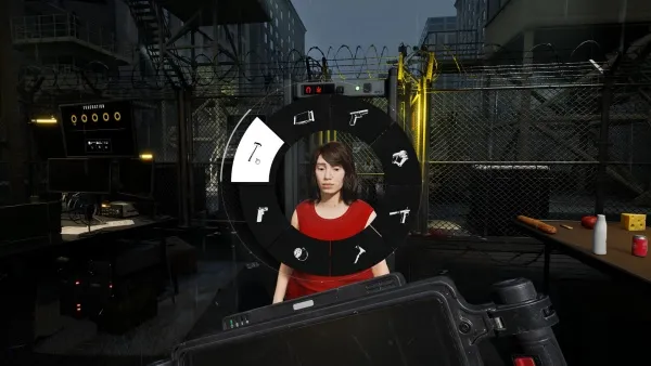 A woman in a red top stands in front of a futuristic control panel with various icons and symbols, including guns and other equipment. The setting appears to be an industrial or urban environment at night, with metal fences, surveillance cameras, and dim lighting. The perspective is from behind the camera lens, which is visible in the foreground.