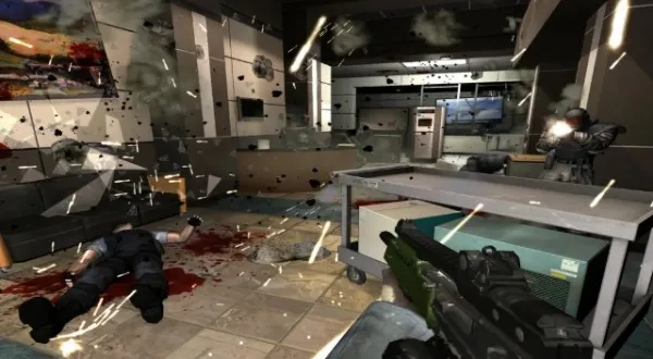 A first-person shooter video game scene set in a futuristic, high-tech facility with debris flying around. The player is holding a gun and aiming at an enemy character on the right side of the screen. There are two other characters lying on the floor, one closer to the left wall and another near the center of the room. The environment includes scattered equipment, monitors, and broken glass. The atmosphere is intense and chaotic, with sparks and smoke filling the air.